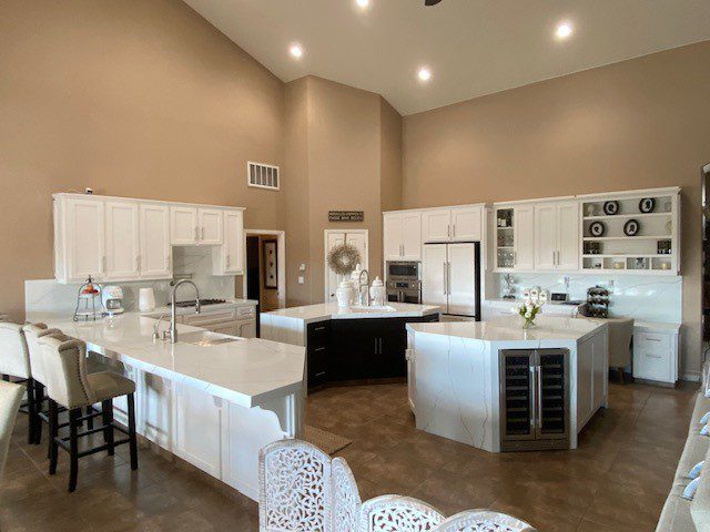  Large outdoor kitchen setup with a grill and sink, ideal for entertaining guests.